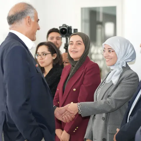 Ambassador Talwar greets a student